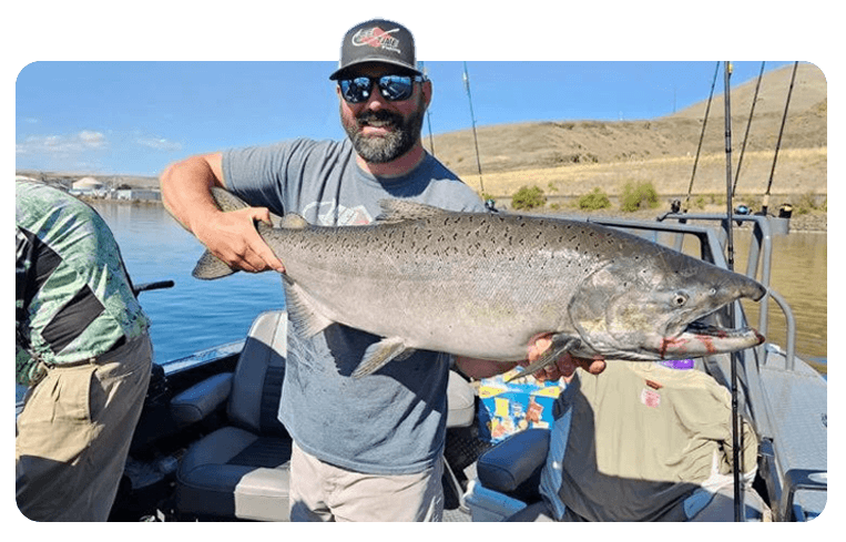 Angler holding a chinook salmon